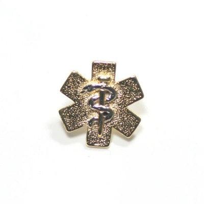 broche medicina folheado a ouro em um fundo branco. a peça é formada por uma serpente que se entrelaça em um bastão.