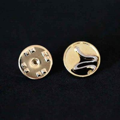 Broche Biologia folheado a ouro em um fundo preto. A peça replica um óvulo sendo fecundado, representando a origem da vida.